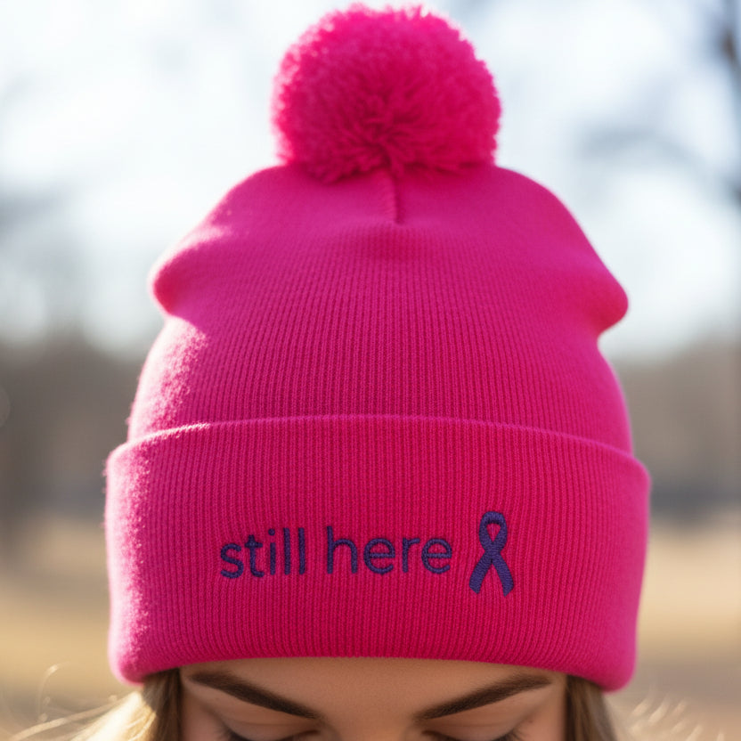 Still Here Pom-Pom Beanie – Epilepsy Awareness Knit Hat with Purple Ribbon