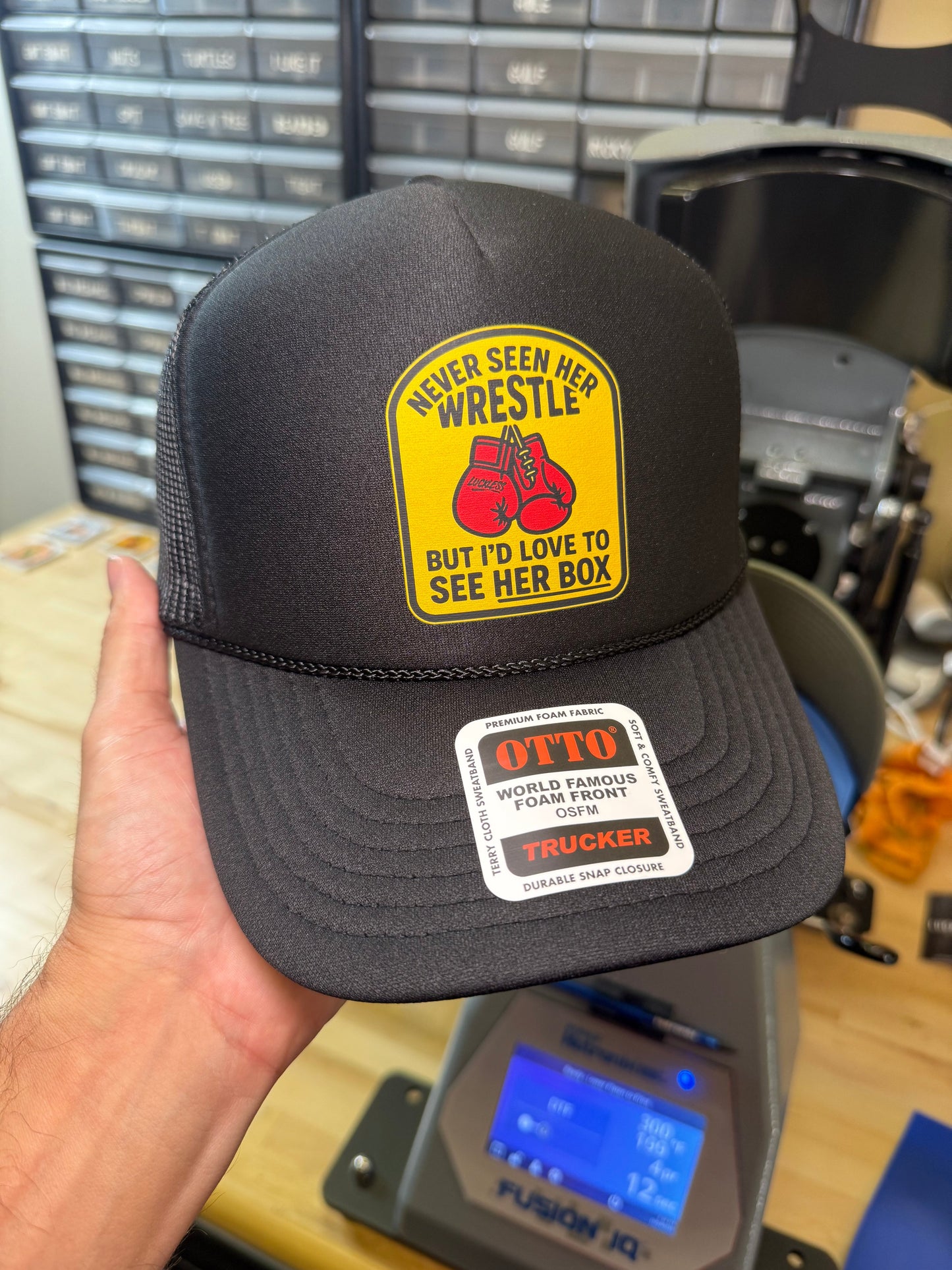 Love To See Her Box Trucker Hat by Luckless Outfitters