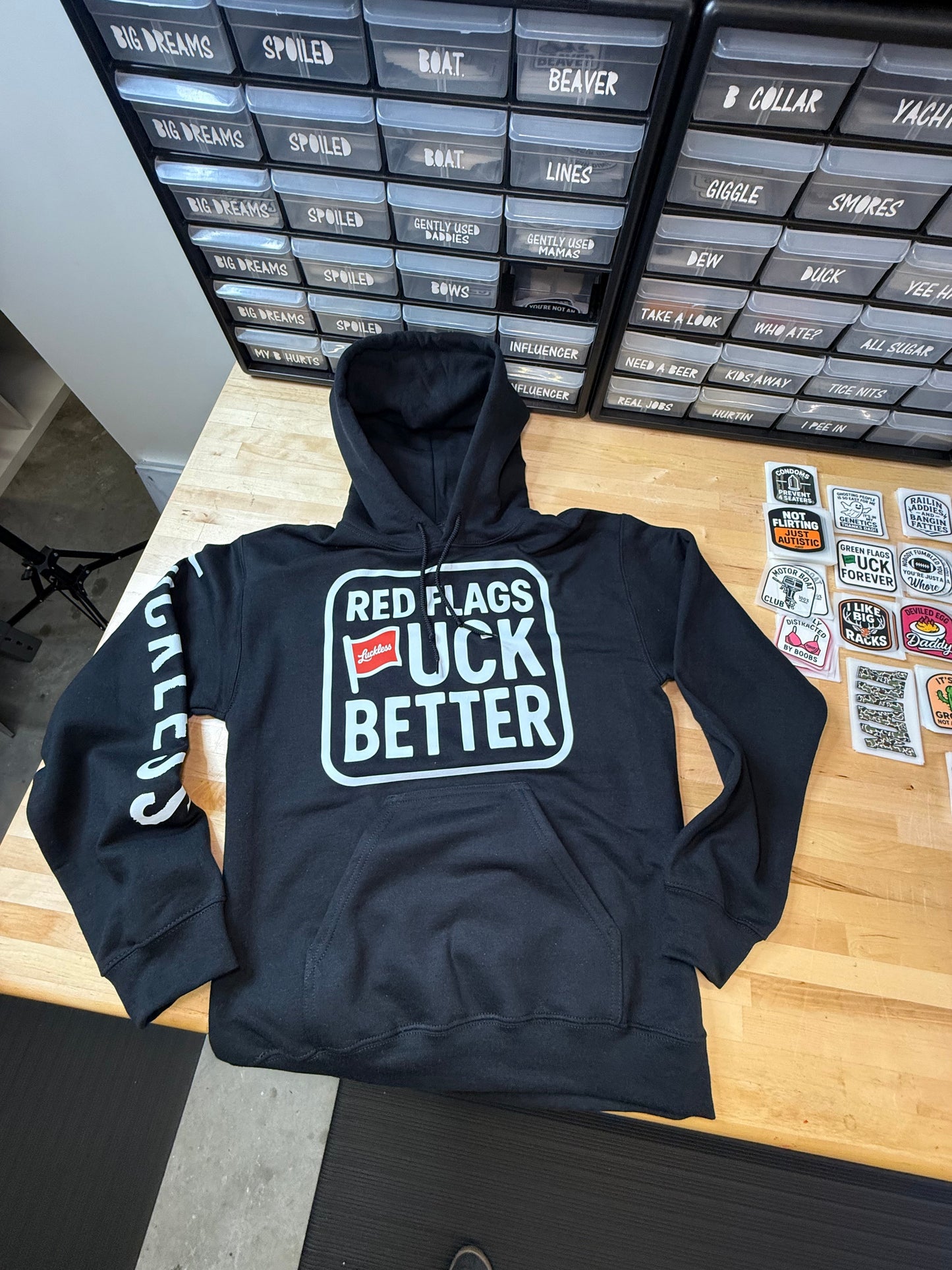 Red Flags Fuck Better Hoodie by Luckless Outfitters - Men's and Women's Funny Streetwear Pullover in Black or Bright Red with Bold Graphic Design
