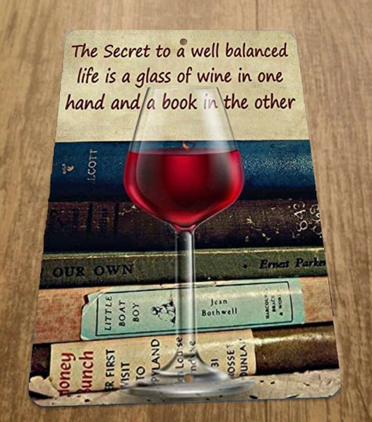 The Secret to a well balanced life is a glass of wine and a book 8x12 Metal Bar Sign